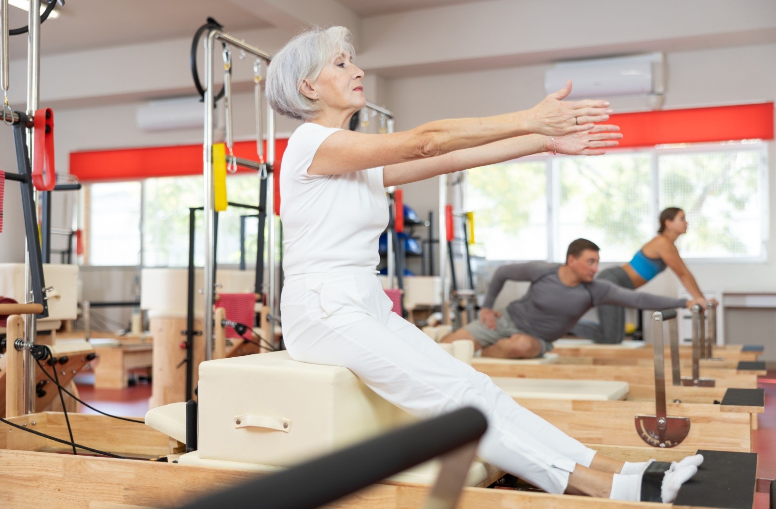 A senior works out during a pilates class.
